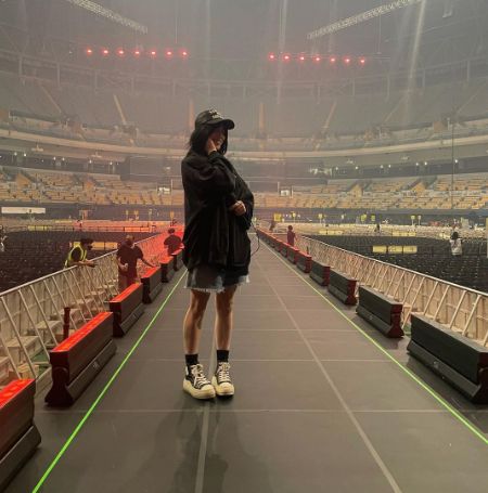 Billie Eilish took a picture standing in the center of an empty stage.